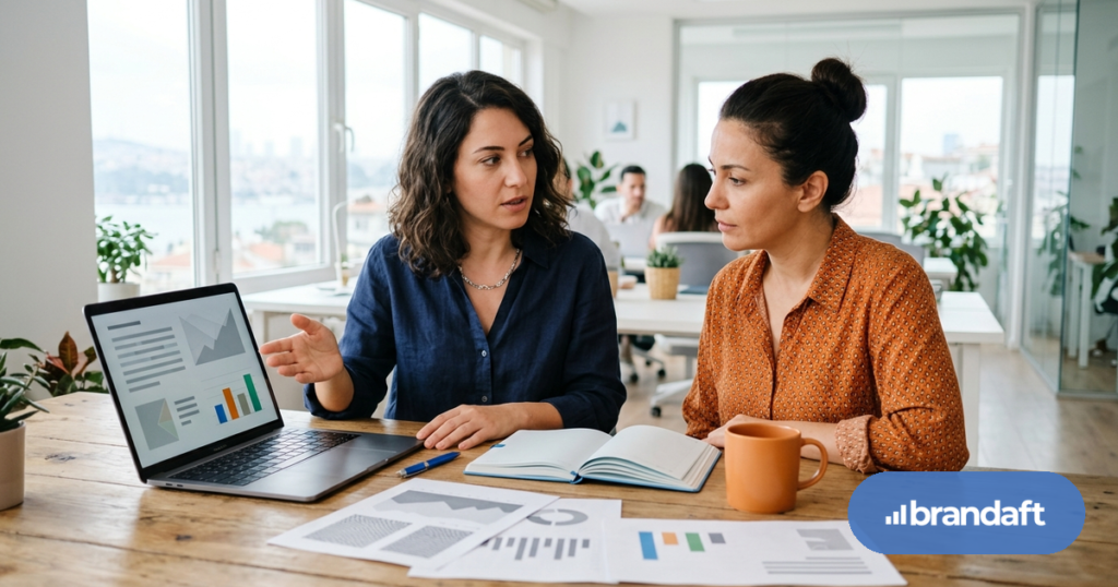 An SEO consultant explains a proposal to a business owner at a bright office table.